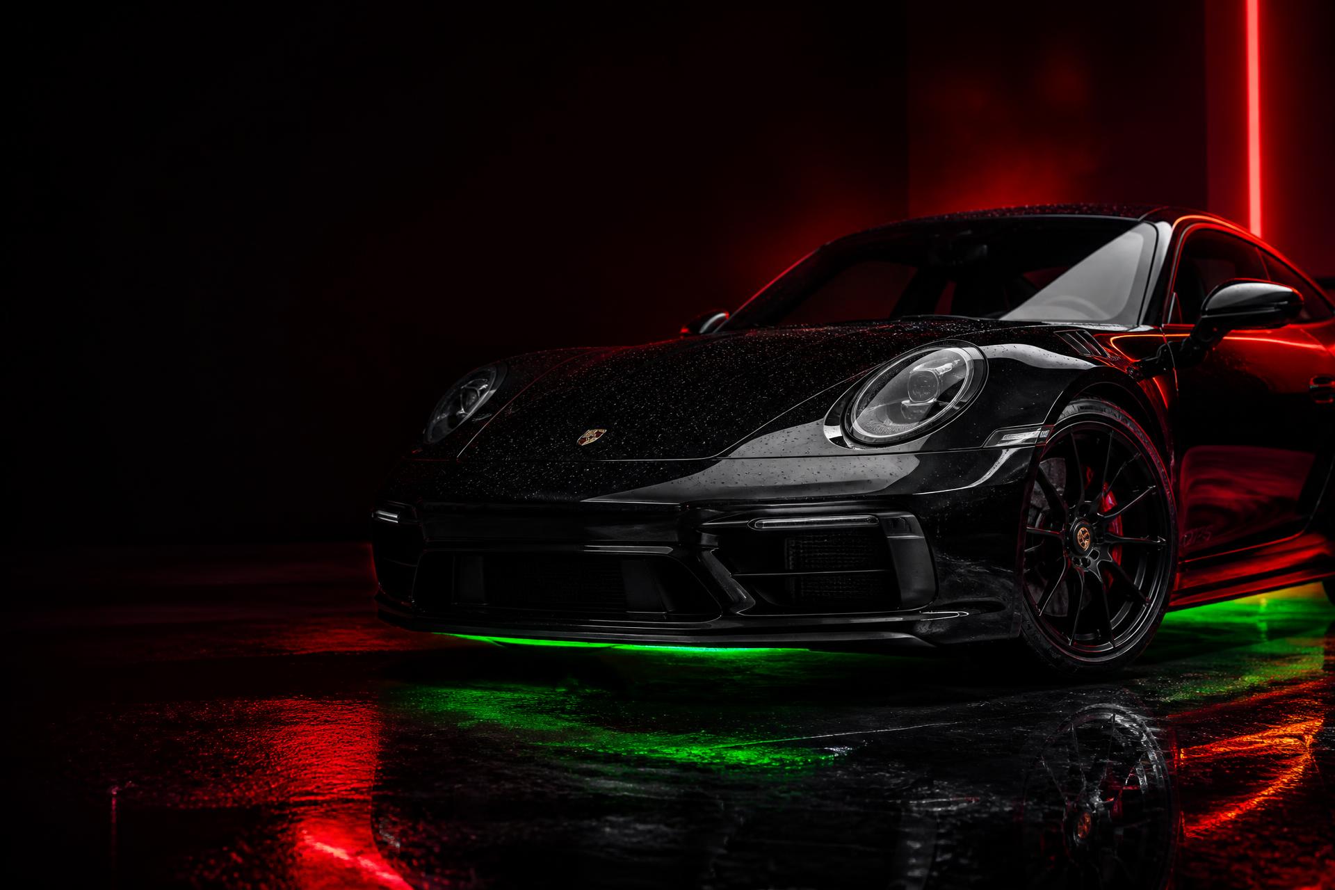 Detailed luxury sports car under red and green lighting